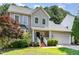 Charming two-story home boasts a well-maintained lawn, attached garage, and beautiful landscaping at 8512 Erinsbrook Dr, Raleigh, NC 27617
