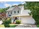 Charming two-story home boasts a well-maintained lawn, attached garage, and beautiful landscaping at 8512 Erinsbrook Dr, Raleigh, NC 27617