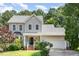 Charming two-story home boasts a well-maintained lawn, attached garage, and beautiful landscaping at 8512 Erinsbrook Dr, Raleigh, NC 27617