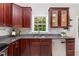 Kitchen with granite countertops, stainless steel dishwasher, and wood cabinets at 8512 Erinsbrook Dr, Raleigh, NC 27617