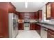 Kitchen with stainless steel appliances, granite countertops, and light tile flooring at 8512 Erinsbrook Dr, Raleigh, NC 27617