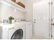 Laundry room featuring a washer, dryer, and shelving at 8512 Erinsbrook Dr, Raleigh, NC 27617
