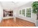 Open-concept living room flows into the kitchen and features hardwood floors and a large window at 8512 Erinsbrook Dr, Raleigh, NC 27617