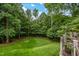 Spacious backyard features lush greenery and a fire pit for outdoor gatherings at 8608 Valley Brook Dr, Raleigh, NC 27613