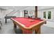 Basement game room features a pool table with red felt and warm wooden accents at 8608 Valley Brook Dr, Raleigh, NC 27613