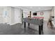 Basement game room features a foosball table and a view to the fireplace at 8608 Valley Brook Dr, Raleigh, NC 27613
