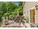 Large deck offers outdoor dining space with views of lush greenery at 8608 Valley Brook Dr, Raleigh, NC 27613