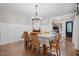 Formal dining room featuring wainscoting, hardwood floors, and a chandelier at 8608 Valley Brook Dr, Raleigh, NC 27613