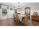 Elegant dining room featuring hardwood floors, wainscoting and stylish light fixtures at 8608 Valley Brook Dr, Raleigh, NC 27613