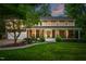 Charming two-story home featuring a welcoming front porch, manicured lawn, and beautiful landscaping at 8608 Valley Brook Dr, Raleigh, NC 27613