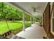 Inviting front porch featuring a porch swing, ceiling fans, and views of the manicured lawn at 8608 Valley Brook Dr, Raleigh, NC 27613