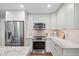 Well-equipped kitchen with stainless steel appliances, granite counters, and white cabinetry at 8608 Valley Brook Dr, Raleigh, NC 27613