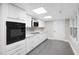 Modern kitchen with stainless appliances, white cabinetry, and tile backsplash at 8608 Valley Brook Dr, Raleigh, NC 27613