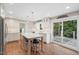 Bright kitchen featuring an island with barstool seating and stainless steel appliances at 8608 Valley Brook Dr, Raleigh, NC 27613