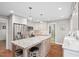 Open kitchen featuring stainless steel appliances, granite countertops, and white cabinetry at 8608 Valley Brook Dr, Raleigh, NC 27613