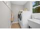 Well-equipped laundry area with modern appliances and a utility sink at 8608 Valley Brook Dr, Raleigh, NC 27613