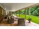 Inviting covered patio with seating and view of the expansive backyard and mature trees at 8608 Valley Brook Dr, Raleigh, NC 27613