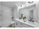Well-lit bathroom featuring dual sinks, white cabinets and a shower/tub combination at 8732 Wardle Ct, Wake Forest, NC 27587