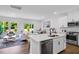 Open floor plan kitchen with stainless appliances, island and views to living and dining rooms at 8732 Wardle Ct, Wake Forest, NC 27587
