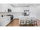 Bright kitchen features white cabinets, stainless steel appliances and island with seating at 8732 Wardle Ct, Wake Forest, NC 27587