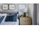 Tastefully decorated bedroom with a stylish bedside table, decorative lamps, and serene artwork for a peaceful retreat at 8732 Wardle Ct, Wake Forest, NC 27587