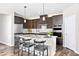 Modern kitchen with dark wood cabinets, granite countertops, stainless steel appliances, and center island at 904 Emmer St, Rolesville, NC 27571