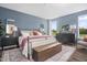 Stylish bedroom with large windows, a cozy bed, and elegant furnishings, perfect for relaxation at 904 Emmer St, Rolesville, NC 27571