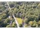 Aerial view of property with expansive green space, mature trees, and neighborhood setting at 938 Hargrove St, Henderson, NC 27536
