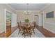 Dining room with a wooden table and chairs set on an area rug over hardwood floors at 938 Hargrove St, Henderson, NC 27536