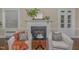 A charming fireplace with mantel and accents, flanked by seating, with hardwood floors at 938 Hargrove St, Henderson, NC 27536