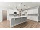 Modern kitchen featuring white cabinets, a center island, pendant lighting, and stainless steel appliances at 94 Lipford Ct # 40, Selma, NC 27576