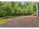 The backyard has a brick patio with steps to a screened in porch at 100 Lexington Ave, Zebulon, NC 27597