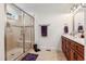 Bathroom featuring glass shower, neutral tile, and ample counter space at 100 Lexington Ave, Zebulon, NC 27597
