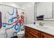 Charming bathroom with quirky octopus shower curtain and wood vanity at 100 Lexington Ave, Zebulon, NC 27597
