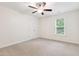 Bright bedroom with a ceiling fan and a large window allowing for plenty of natural light at 100 Lexington Ave, Zebulon, NC 27597