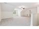 Spacious bonus room has neutral carpet, large window and ceiling fan at 100 Lexington Ave, Zebulon, NC 27597