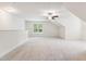 Large bonus room with vaulted ceiling, neutral carpeting, and a window offering natural light at 100 Lexington Ave, Zebulon, NC 27597