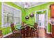 Cozy breakfast nook features bright green walls, natural light, and seating for four at 100 Lexington Ave, Zebulon, NC 27597