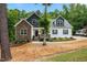 Inviting home with a covered porch, stone details, and a well-maintained yard at 100 Lexington Ave, Zebulon, NC 27597