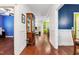 Bright hallway featuring hardwood floors and access to various living spaces in the home at 100 Lexington Ave, Zebulon, NC 27597