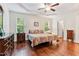 Main bedroom with tray ceiling, hardwood floors, and plenty of natural light at 100 Lexington Ave, Zebulon, NC 27597