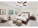 Stylish main bedroom featuring a large window, ceiling fan, and well-appointed decor at 100 Lexington Ave, Zebulon, NC 27597