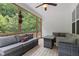 Relaxing screened porch features comfortable seating, ceiling fan, and wooded views at 100 Lexington Ave, Zebulon, NC 27597