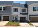 Charming two-story townhome with gray and white siding and attached garage at 1035 Winding Spring Dr, Mebane, NC 27302