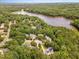 Aerial view of neighborhood near lake featuring tree-lined streets and multiple residential properties at 104 Odessa Cir, Cary, NC 27513