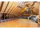 Unfinished attic space with exposed beams and plywood flooring for storage or potential expansion at 104 Odessa Cir, Cary, NC 27513
