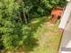 Aerial view of the backyard, complete with wooden deck and steps, lush greenery, and well-maintained lawn at 104 Odessa Cir, Cary, NC 27513