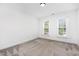 Neutral bedroom with carpet, two windows, and neutral paint at 104 Odessa Cir, Cary, NC 27513