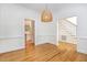 Open dining room with hardwood floors, modern lighting, and views to the kitchen and staircase at 104 Odessa Cir, Cary, NC 27513