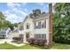 Attractive two-story house featuring black shutters and a brick chimney surrounded by lush trees at 104 Odessa Cir, Cary, NC 27513